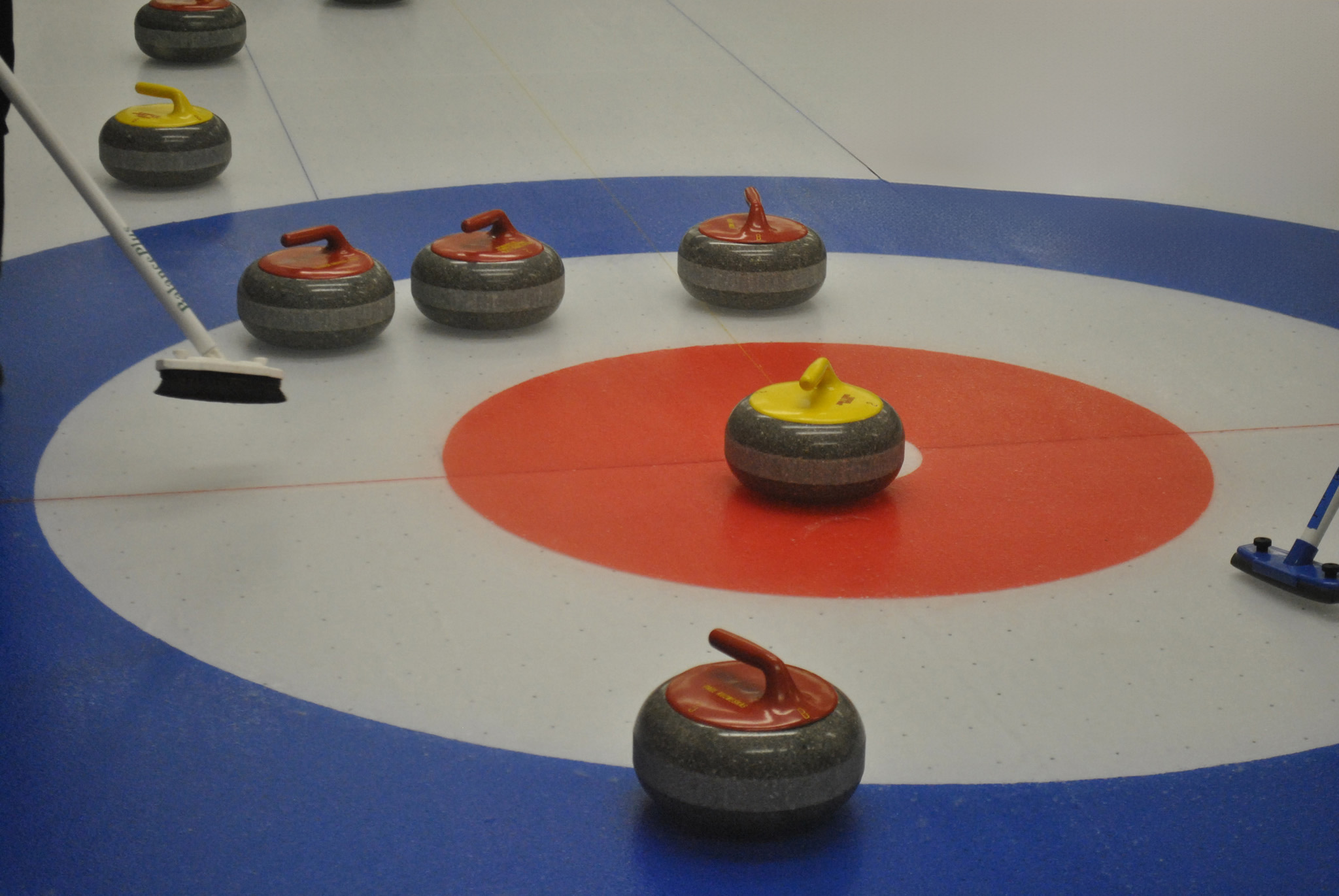 curling stones on a house with yellow on button