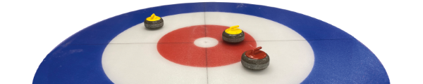 Three stones in a curling house with a yellow closest to the center